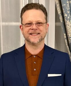 Professional Counselor in Austin Tx Jonathan F. Anderson, LPC-s in a burnt orange knit shirt and blue suit jacket