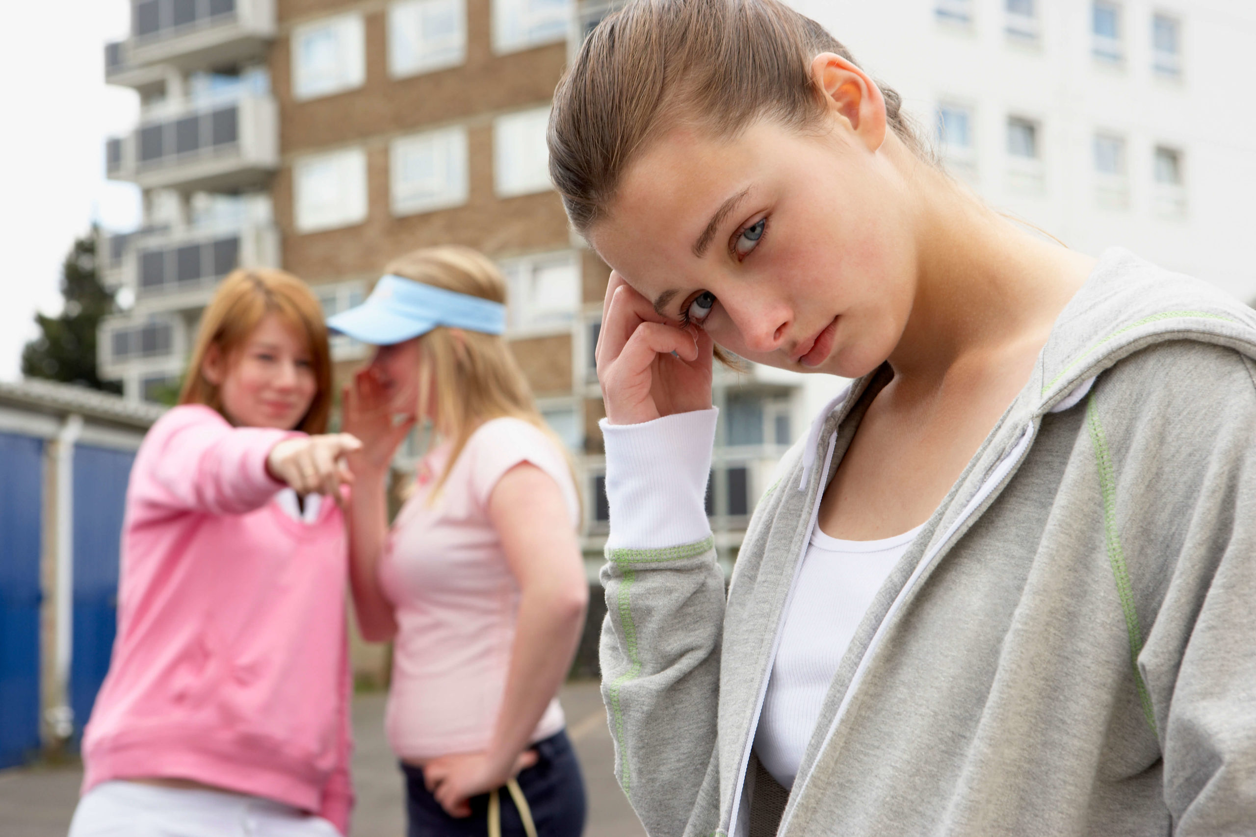an isolated girl being mocked by others. Social anxiety counseling austin tx