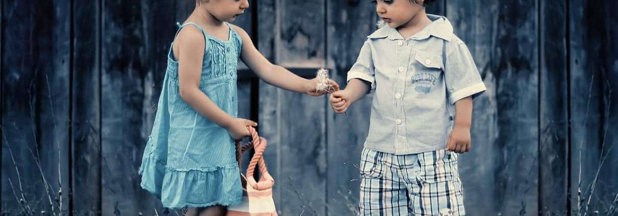 little girl gives little boy a gift. Friendship counseling austin tx
