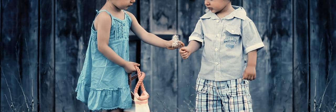 little girl gives a little boy a gift. Friendship counseling austin tx