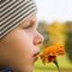 child absorbed in smelling a flower
