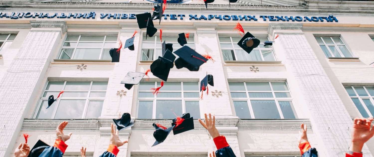 Preparing for college, high school graduates throw their caps in celebration.