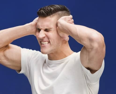 stressed man holding his head