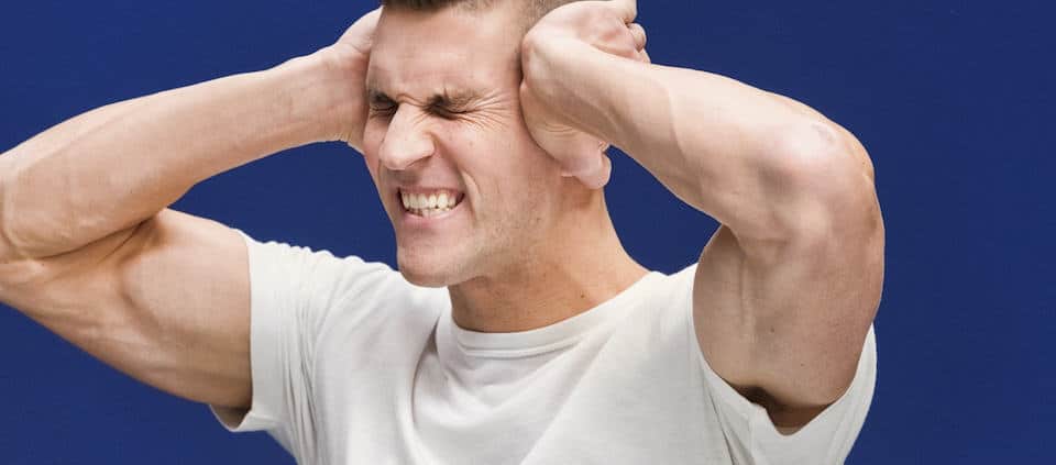 stressed man holding his head