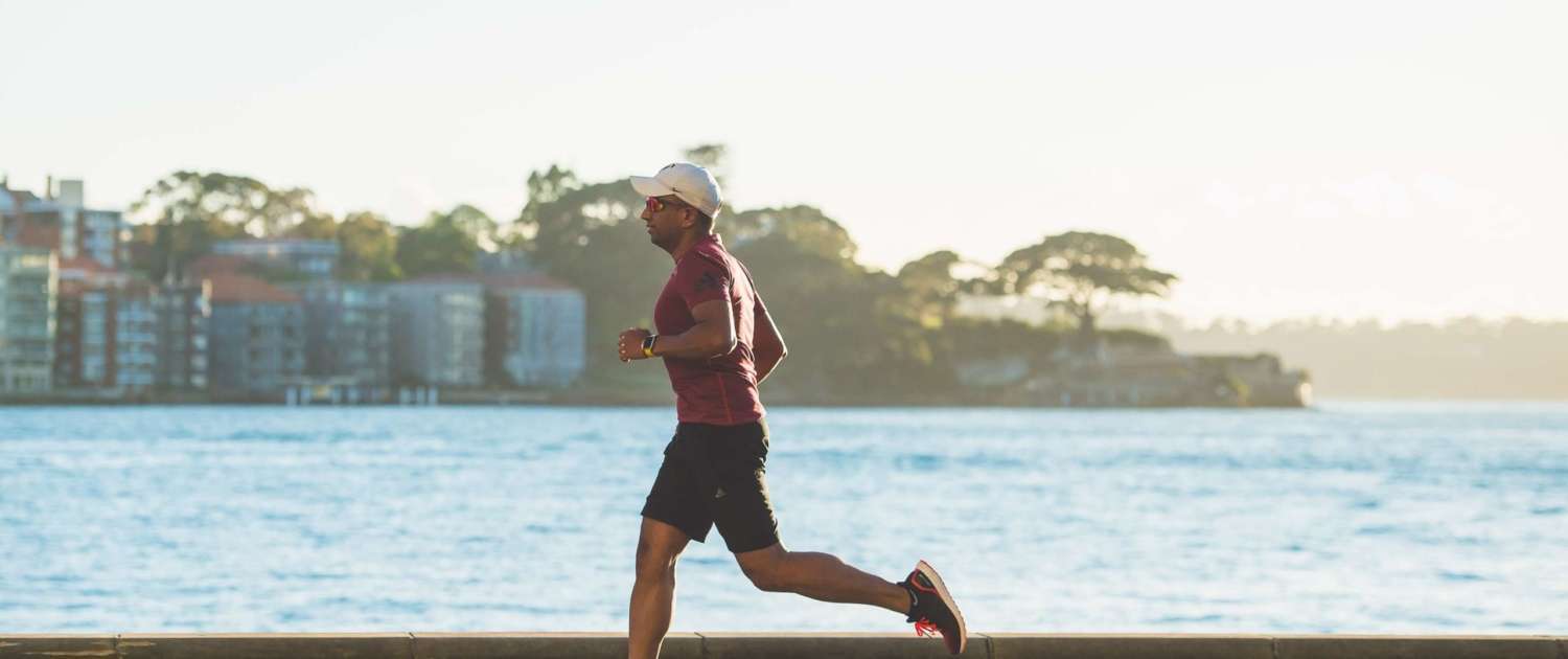 A man running along a waterfront.