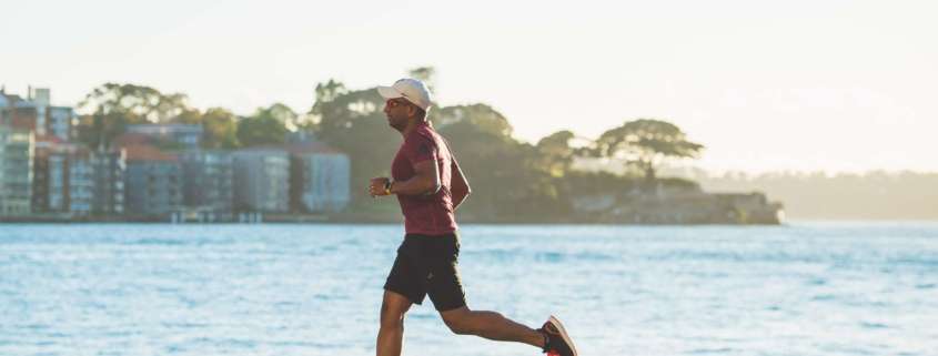 A man running along a waterfront.